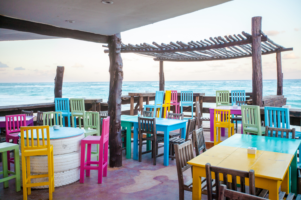 colorful chairs and tables in a Tulum cafe
