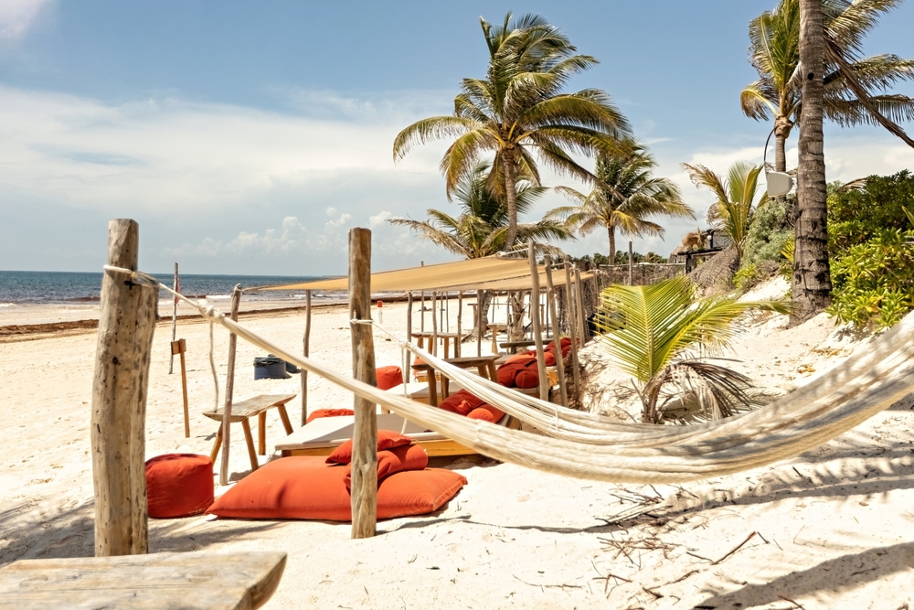 hammocks and orange cushions for relaxing on a Tulum beach