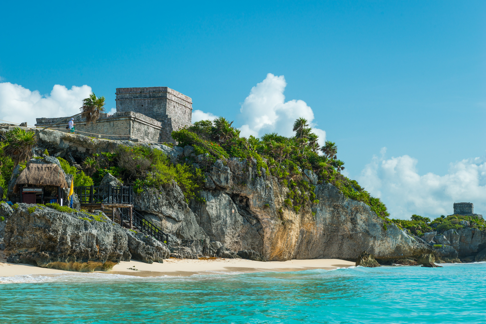 view of the ruins and the beach from the water in Tulum