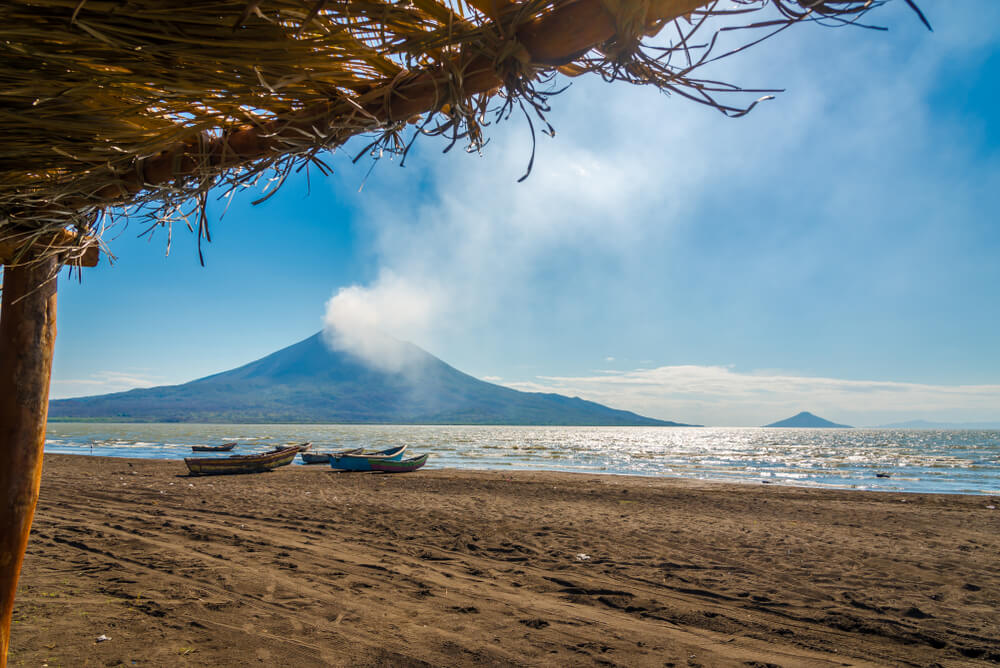 volacano puffing smoke near the beach in Nicaragua