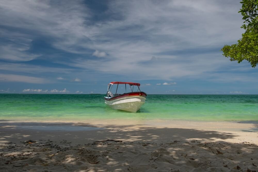 boat near the shore of Playa Blanca, Colombia