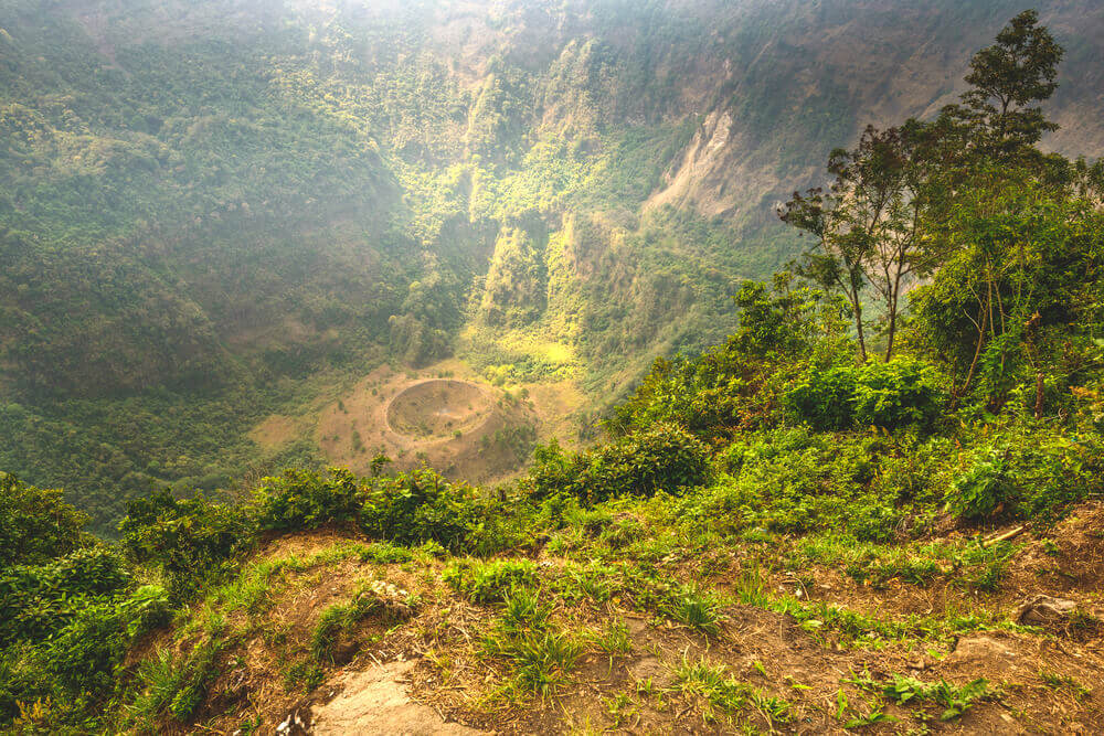 lush valley of El Salvador with a volcanic crater