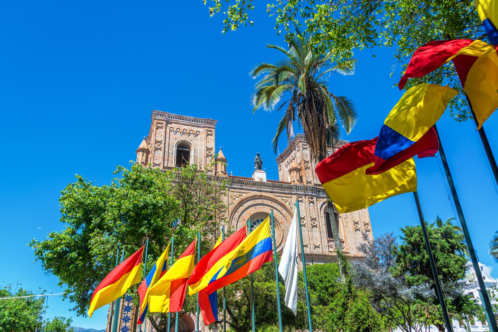 flag in front of church in Cuenca Ecuador