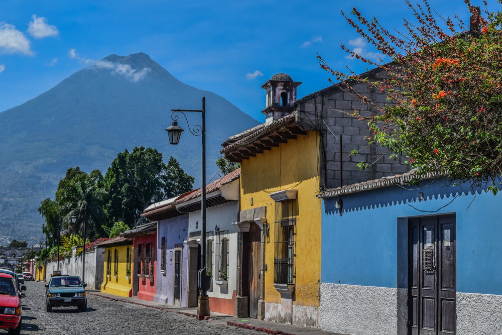 colorful street with volcano in the background