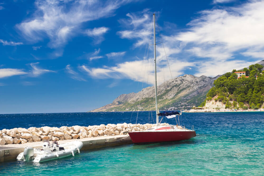 two boats near a rocky pier 