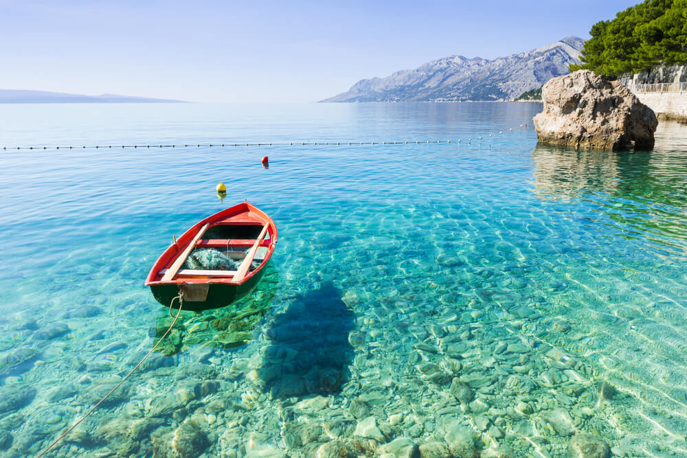 canoe floating in clear water near Brela Beach, Croatia