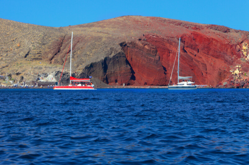 Red Beach in Santorini with catamarans