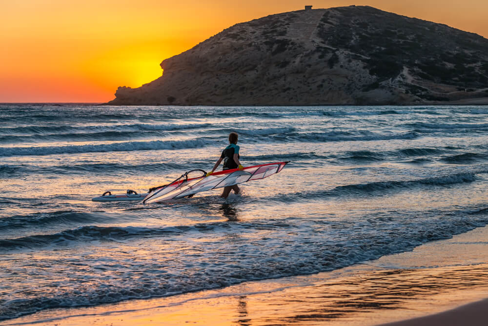 windsurfer in Rhodes, Greece as the sun sets