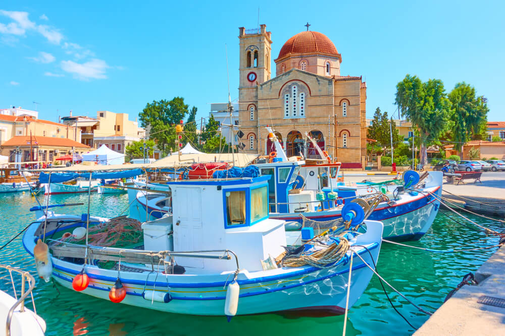 Church and boats on port in Greek Island of Aegina