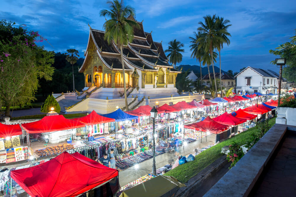 night market food stalls in front of temple in Laos