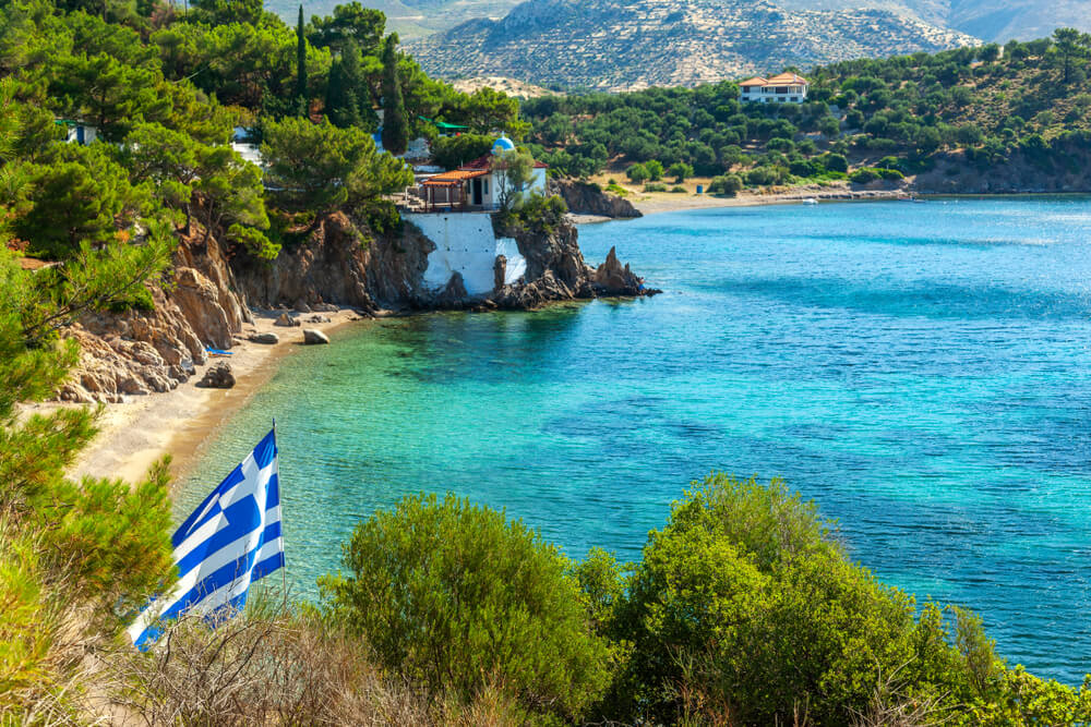 Greek flag over a nude beach