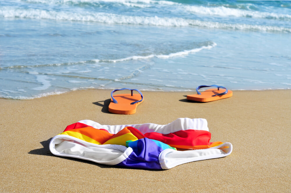 pair of swim trunks and flip flops on a nude beach in Greece