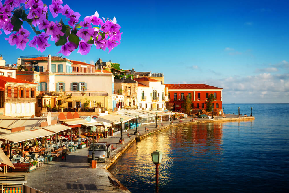 blue skies and busy tavernas on the coast of Greek Island 