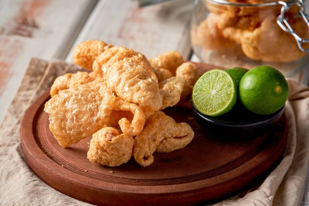 chicharrones on a plate
with limes

