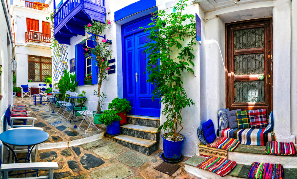 colorful street in Greece for budget travelers
