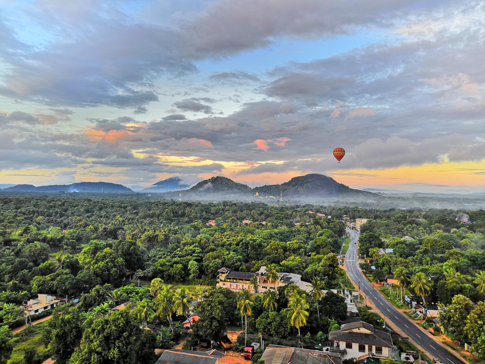 hot air floating over green landscape in Asia