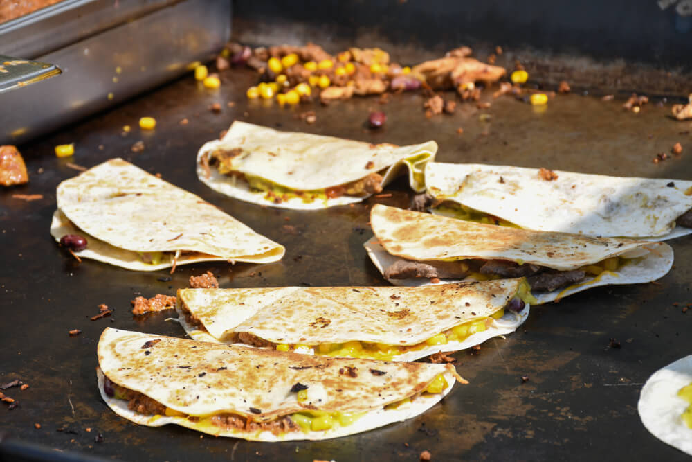 quesadillas cooking on a grill