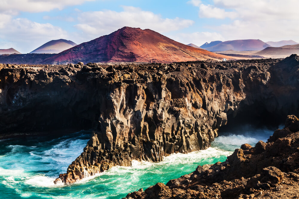 waves hitting the shore near a volcano in Lanzarote