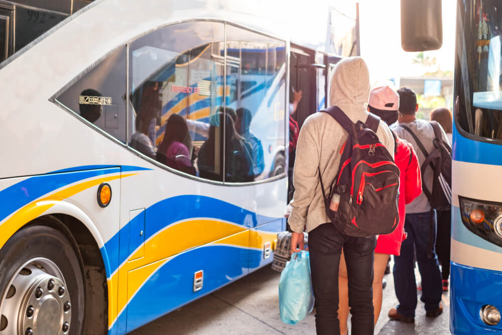 people getting into a slow travel bus in Thailand