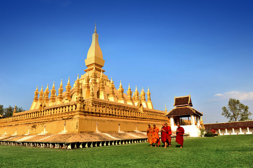 monks at Pha That Luang temple in southeast asia