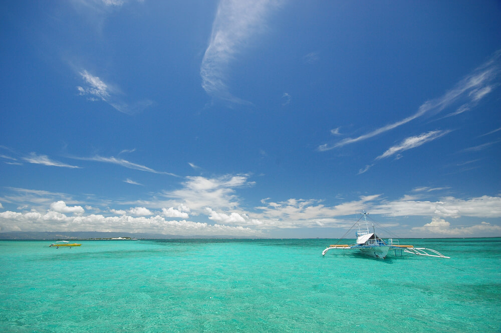 aqua water with boats in Philippines