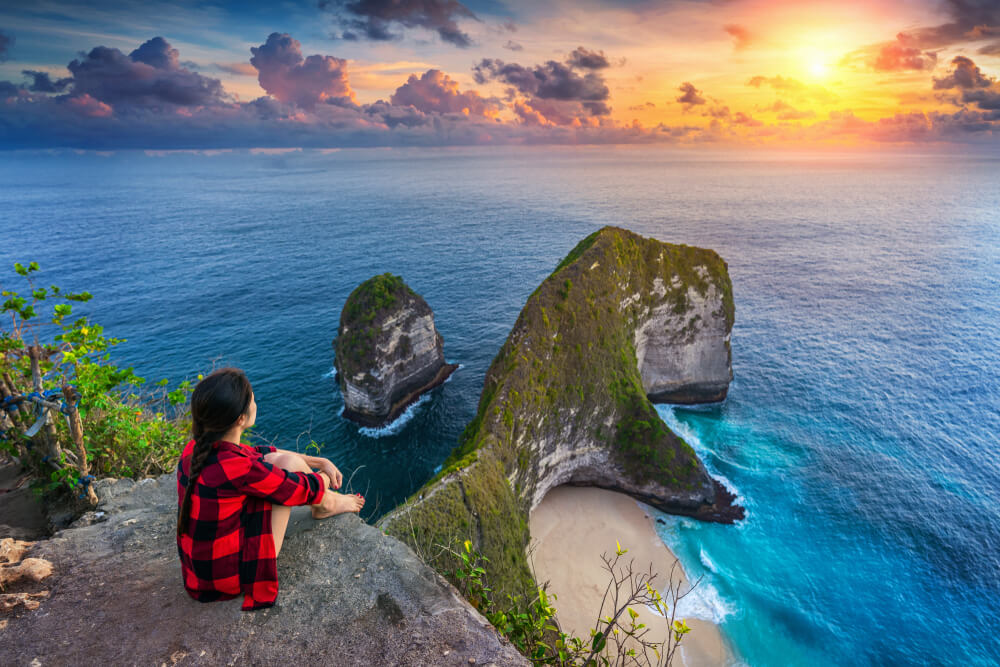 digital nomad girl sitting on top of Nusa Penida Indonesia