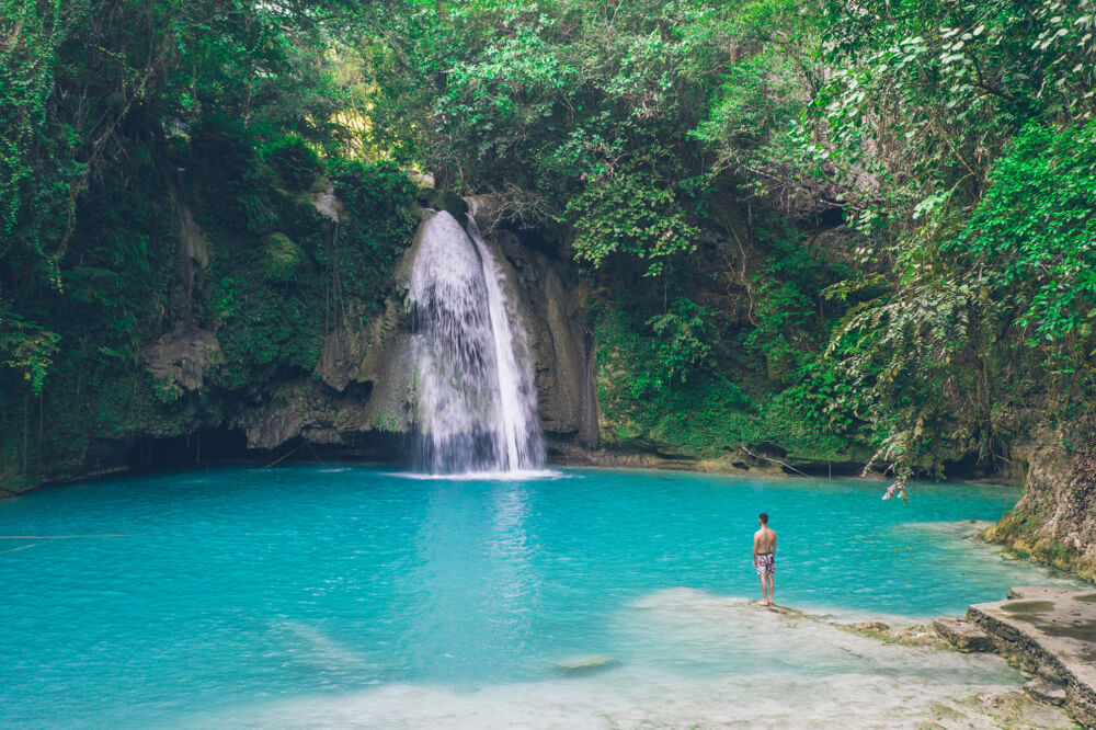 man next to kawasan waterfall day trip from Cebu CIty