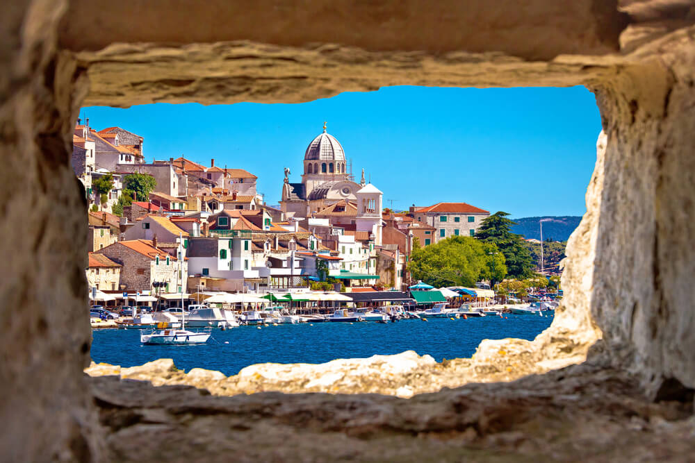 Take a day trip from Split to Sibenik waterfront through a stone opening