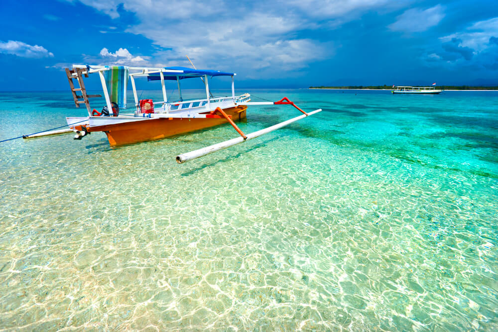 clear water and a boat for island hopping in Indonesia
