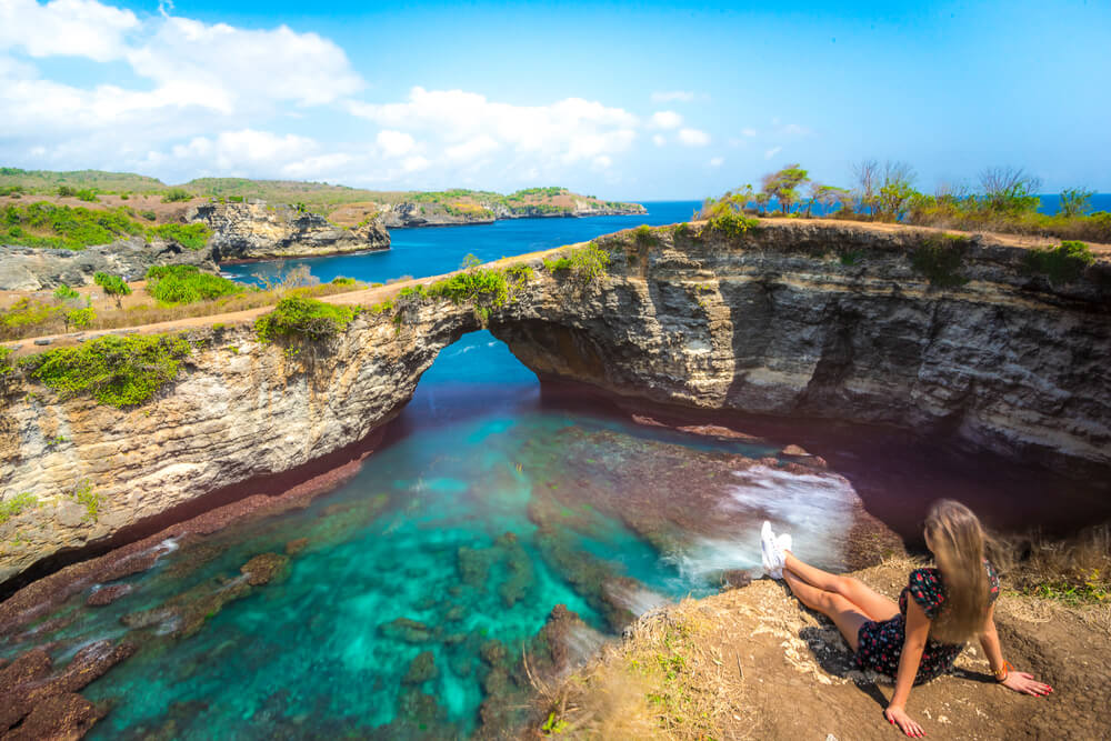 girl overlooking a beach on an island in Indonesia
