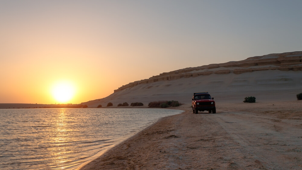 jeep on the sand in the sunset near the Red Sea in Egypt