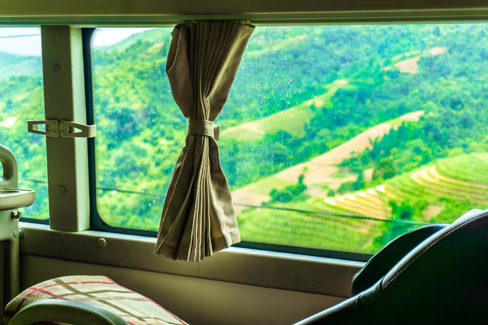 bus window with a view of rice fields
